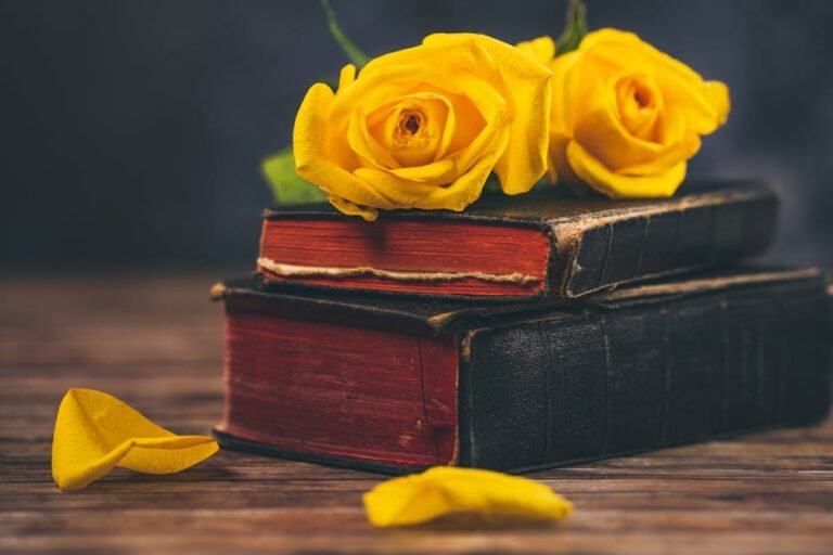 Close-up of yellow roses on vintage books, enhancing elegance and nostalgia.