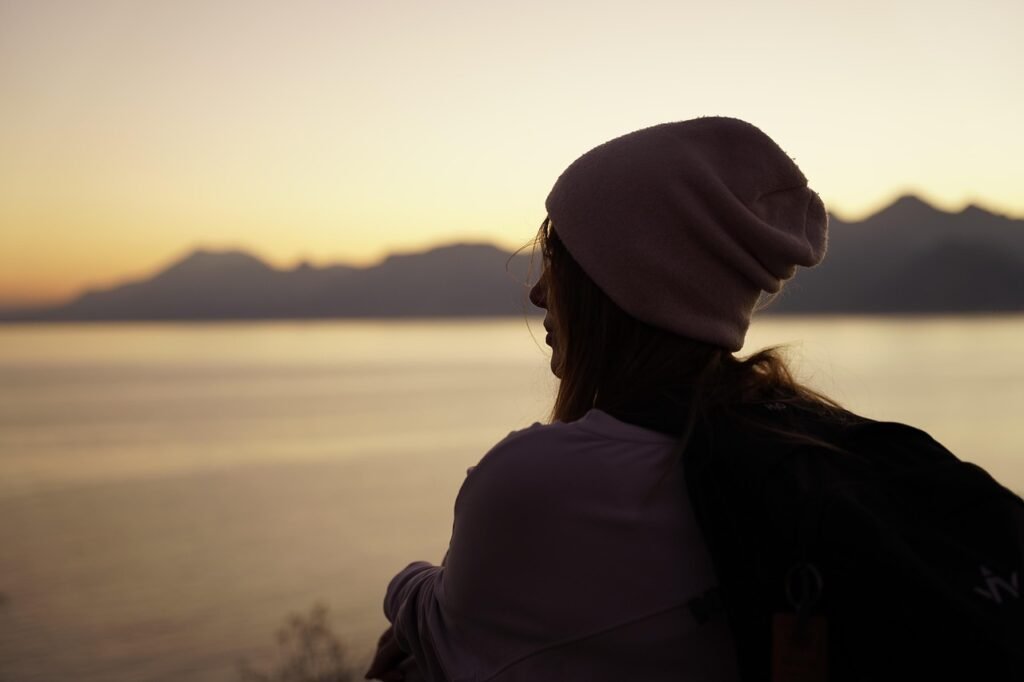 woman, outdoors, sunset, beanie, travel, nature, thinking, looking, nostalgia, dusk