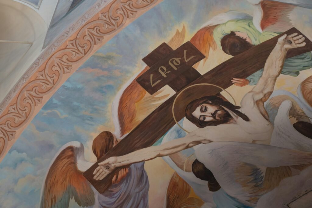 Fresco art depicting Jesus Christ and angels in a religious setting with vibrant colors.